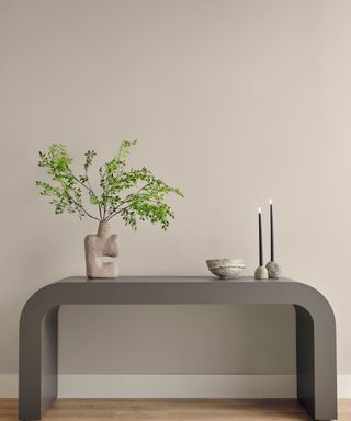 A light gray room with a console table