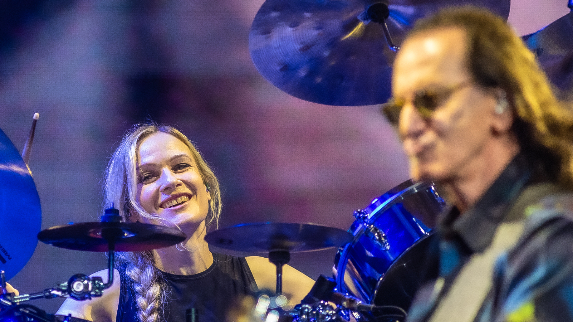 Anika Nilles (L) and Geddy Lee of Rush perform in concert during the Rush: Fifty Something 