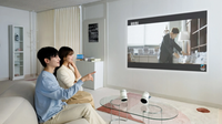 A Samsung press image showing two people using the Freestyle+ portable projector