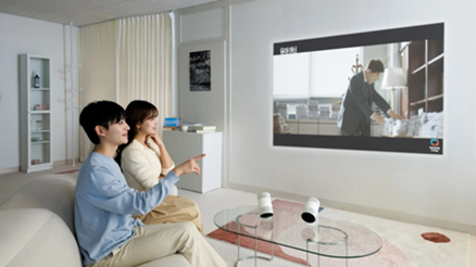A Samsung press image showing two people using the Freestyle+ portable projector
