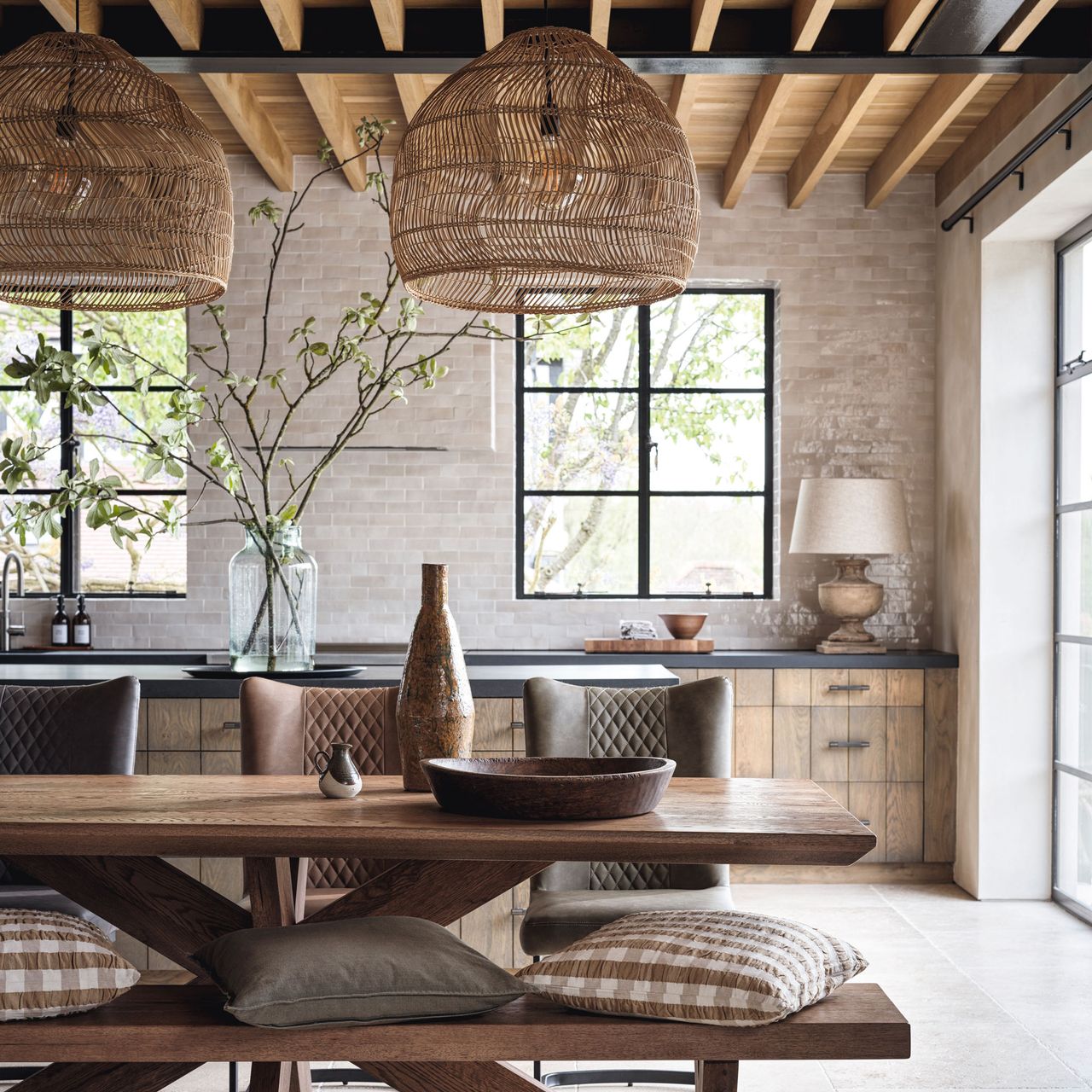 Rustic barn with wooden table with rattan lampshades and large windows