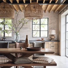 Rustic barn with wooden table with rattan lampshades and large windows