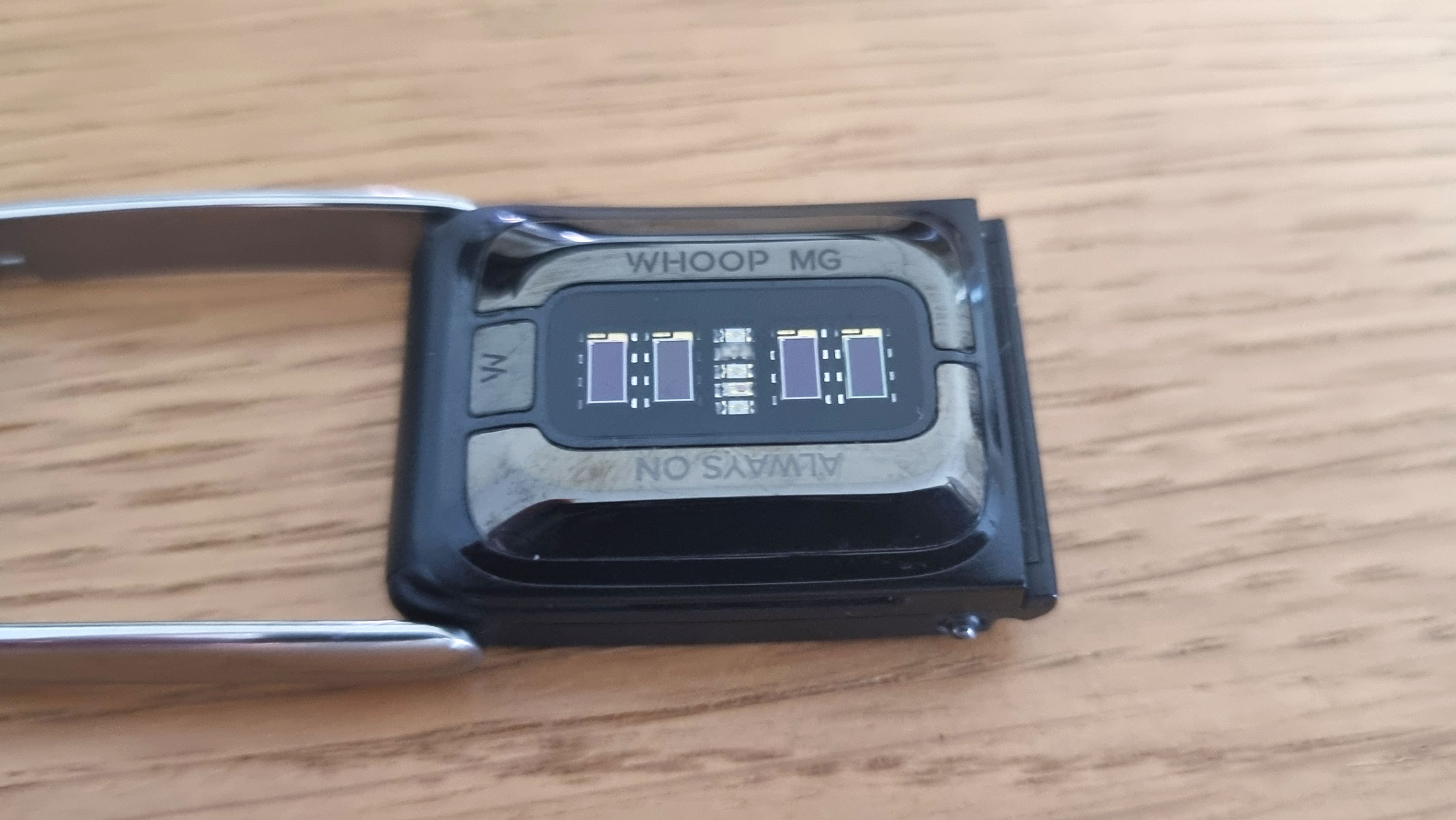 A close-up picture of the heart rate sensor in the Whoop MG fitness tracker