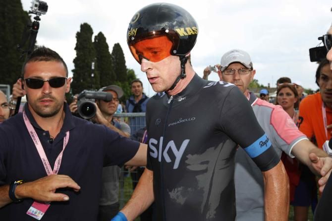 Bradley Wiggins (Sky) makes a quick dash to the team bus after the TT in