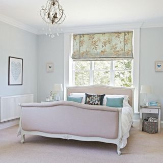 Neutral grey bedroom, carpet flooring, French period style bed position with headboard against window