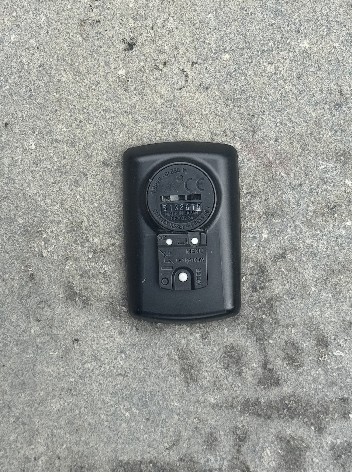 The rear of the Cateye Padrone, all black with a small button battery and three very small buttons to navigate