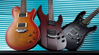 Three Line 6 JTVariax guitars – a JTV59, JTV89 and JTV69 – against a blue grille background