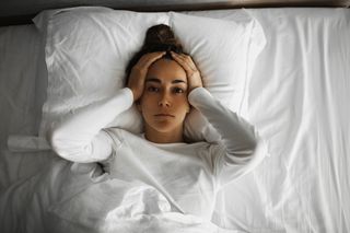 Women in white top having trouble sleeping