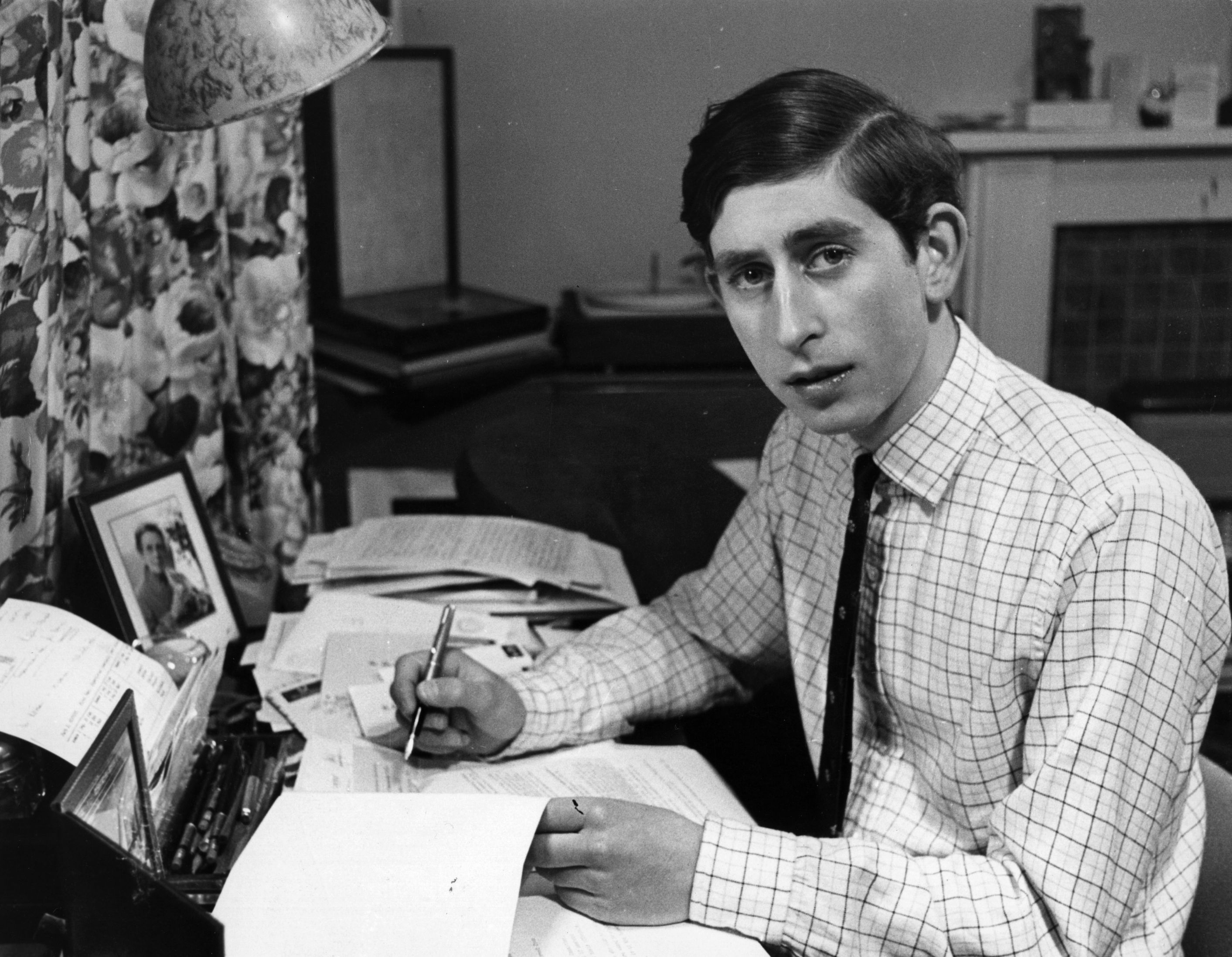 Prince Charles sitting at his desk at Cambridge