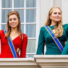 Princess Alexia and Princess Catharina Amalia waving in evening gowns