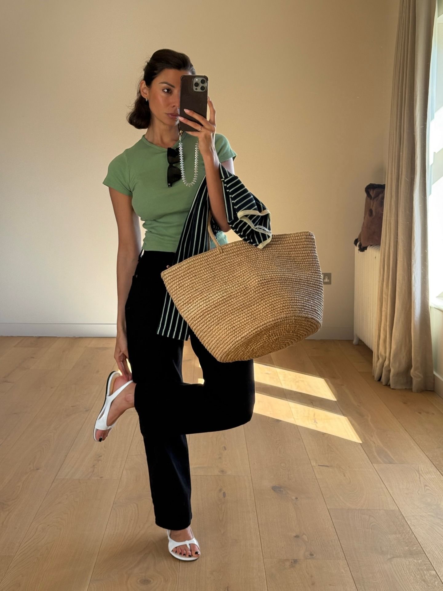 Woman wearing summer 2026 outfit featuring the colorful t-shirt trend.