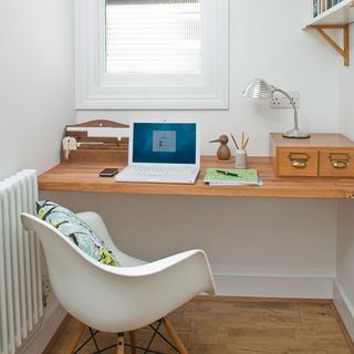 white walls with laptop on table and chair