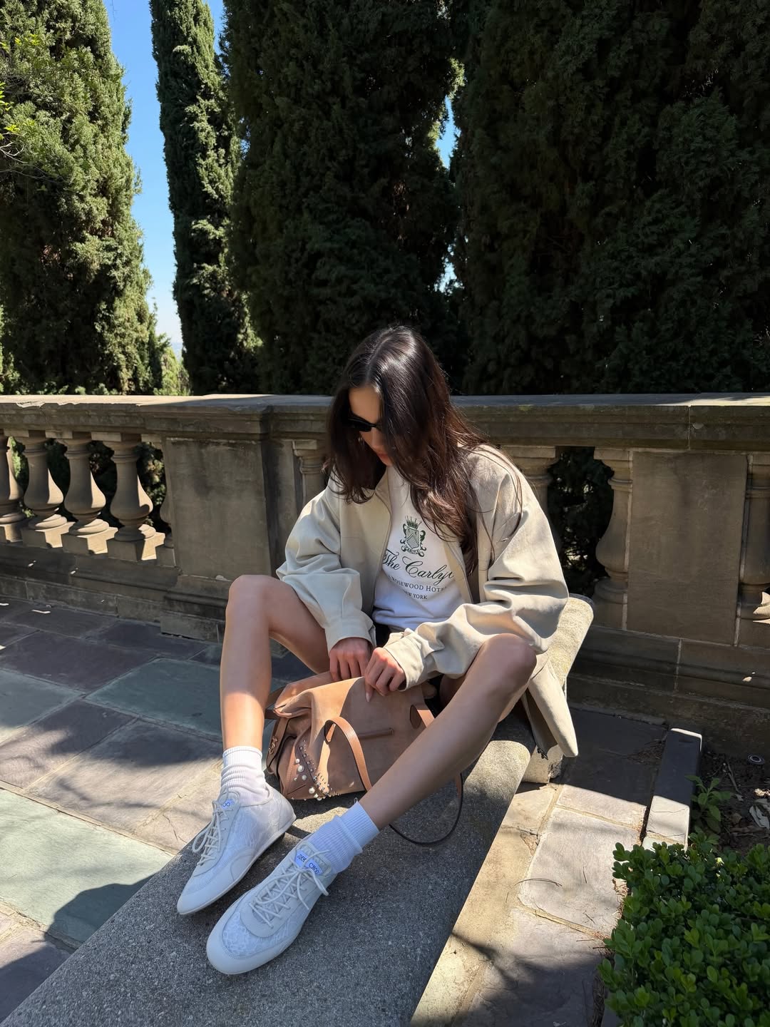 Kelsey Merritt wearing a pair of Jimmy Choo lace up sneakers