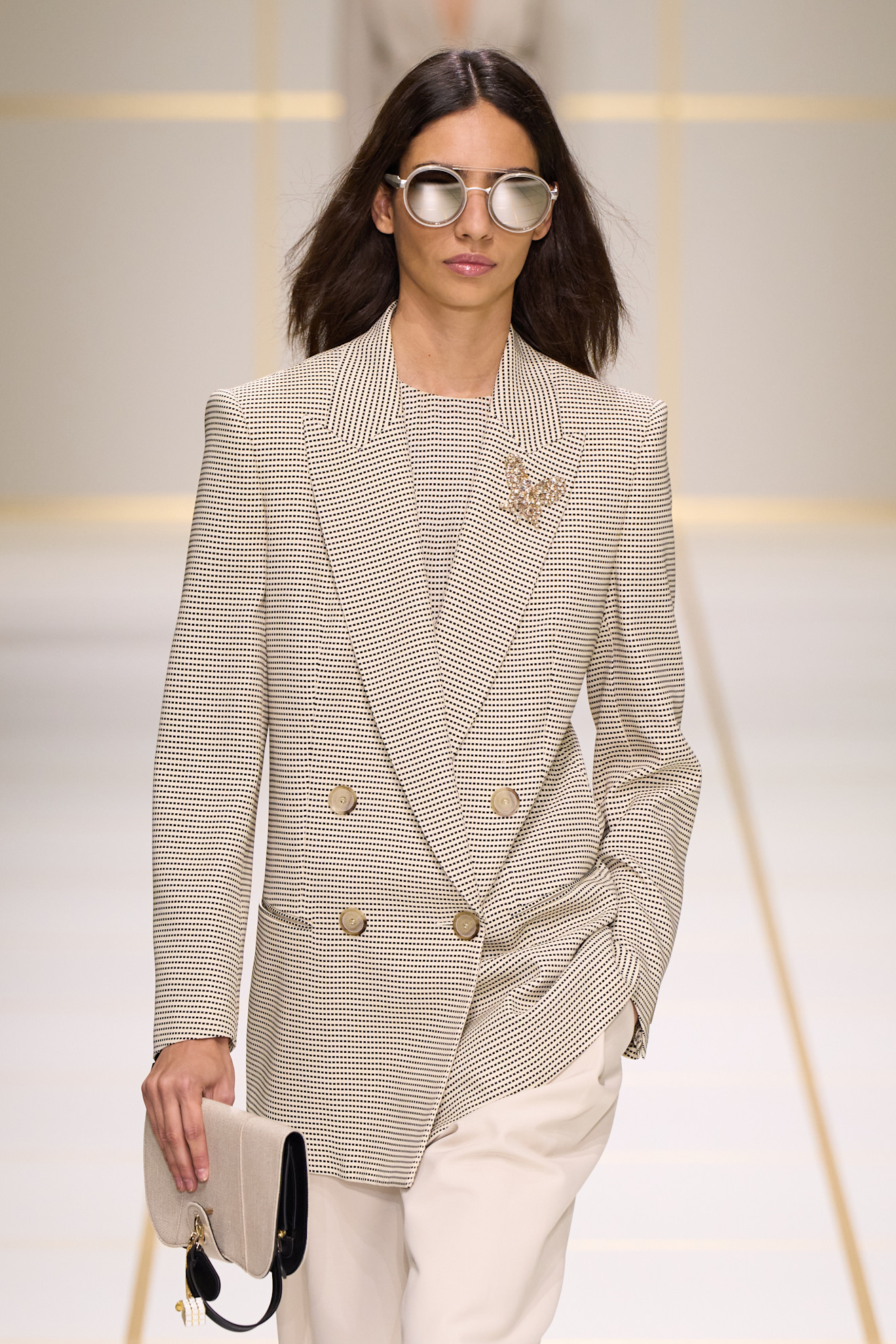 a model walks the giorgio armani s/s 27 runway.