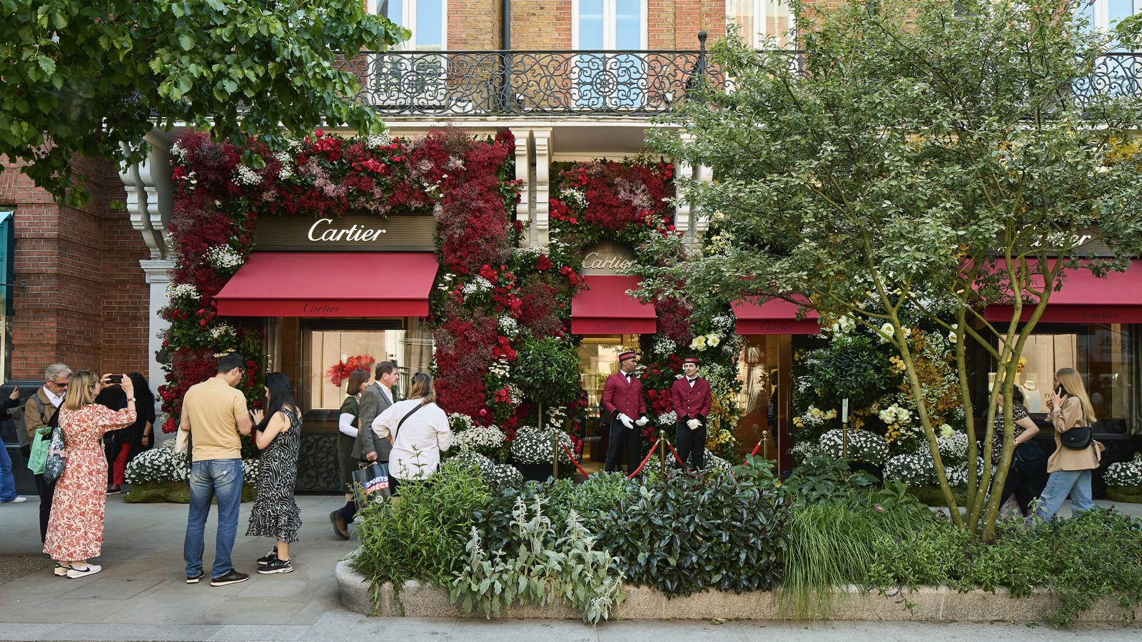 lots of greenery in street outside Cartier shop