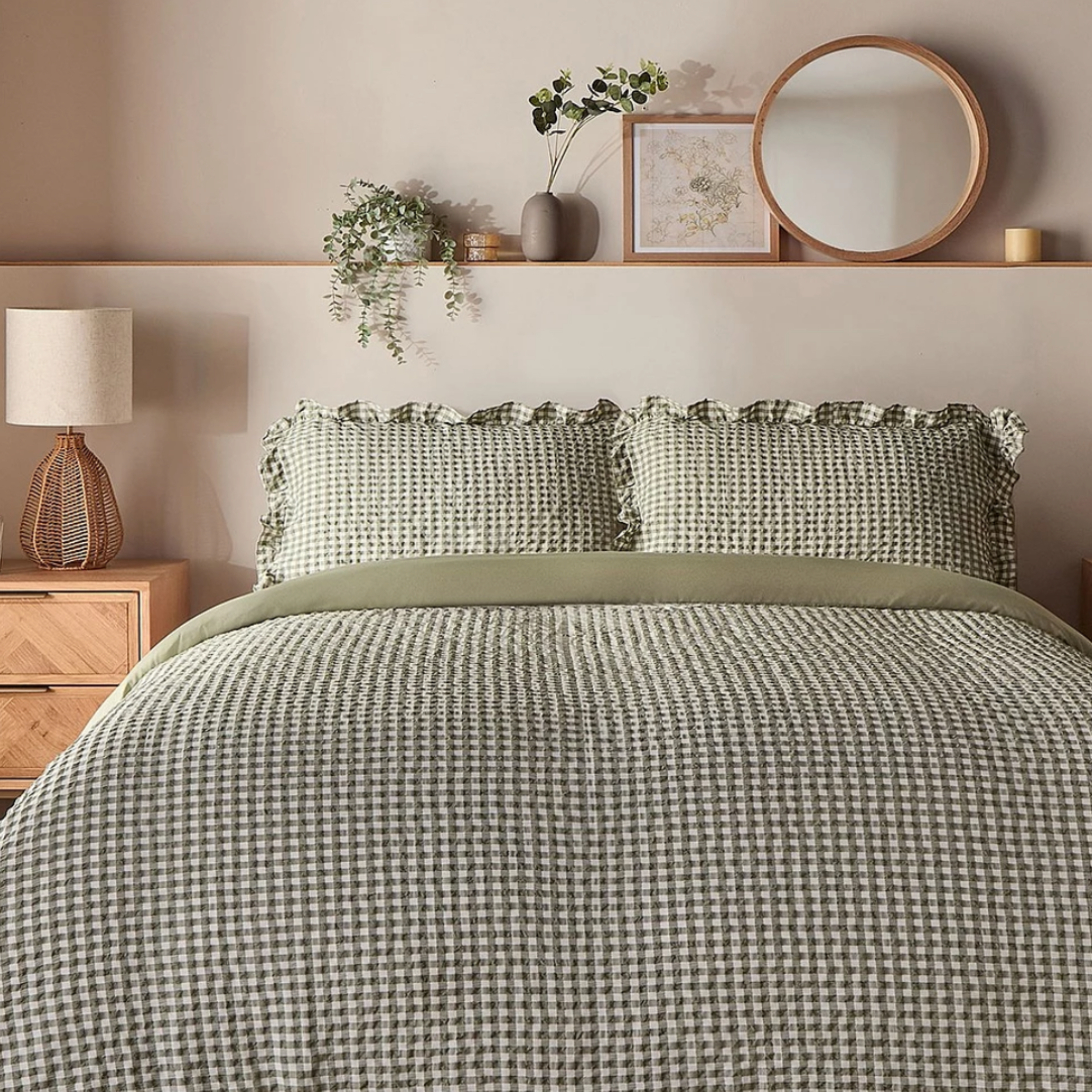 Seersucker gingham bedding styled on a double bed with taupe walls and wooden accessories styled in the wall ledge above