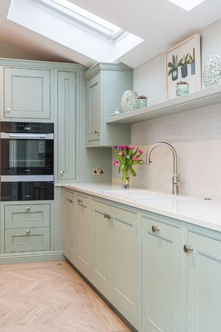 pale blue kitchen with oven and sink