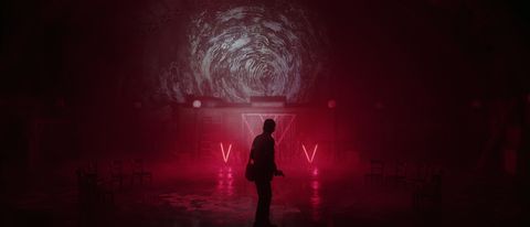 Alan Wake standing in front of a red cult site