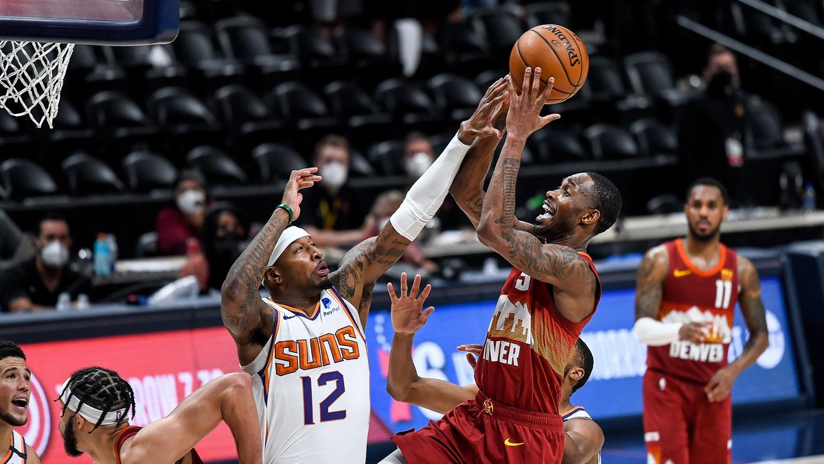 Will Barton #5 of the Denver Nuggets shoots and scores around coverage by Torrey Craig #12 of the Phoenix Suns in Game Four of the Western Conference second-round playoff series at Ball Arena on June 13, 2021 in Denver, Colorado.