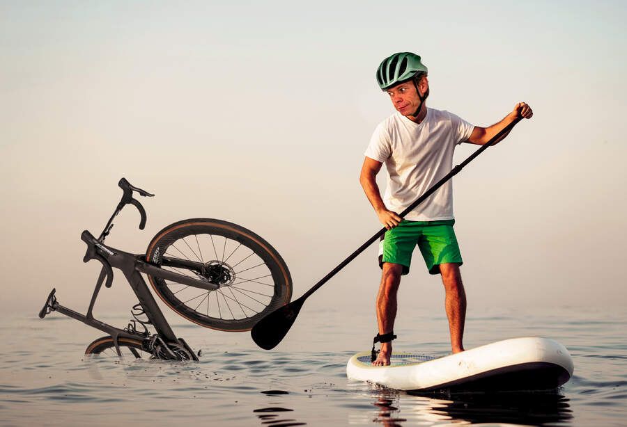 image of hutch paddleboarding away from a bike