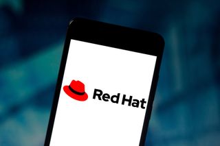 Red Hat logo on a smartphone against a deep blue background