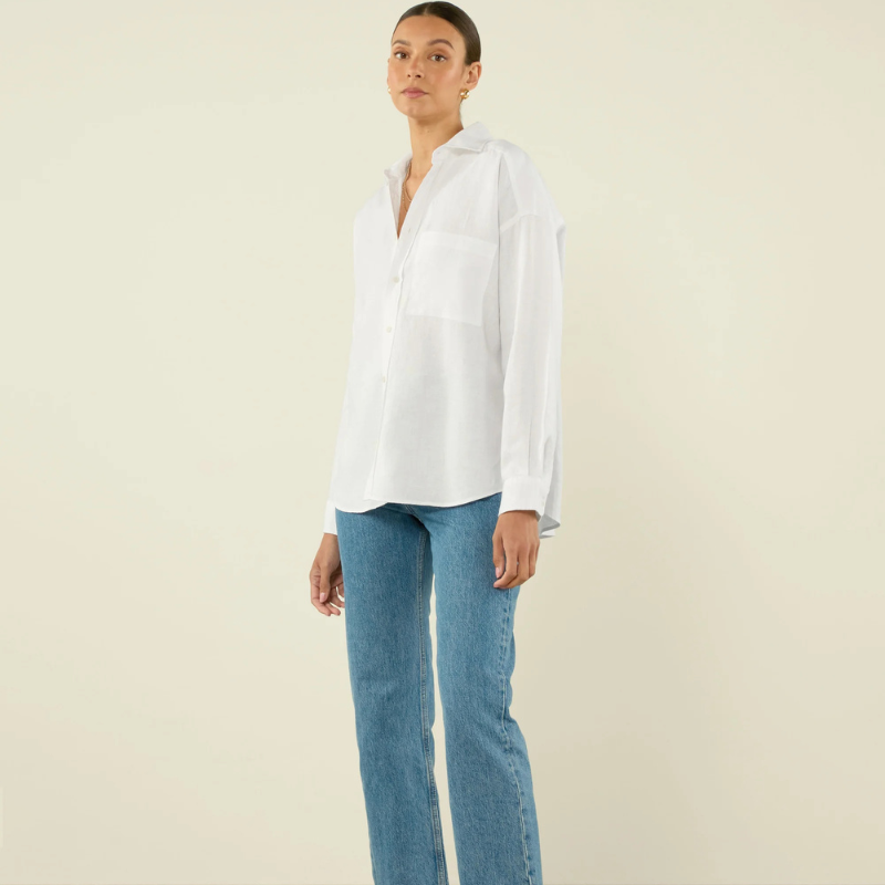 A model wearing a white shirt and jeans
