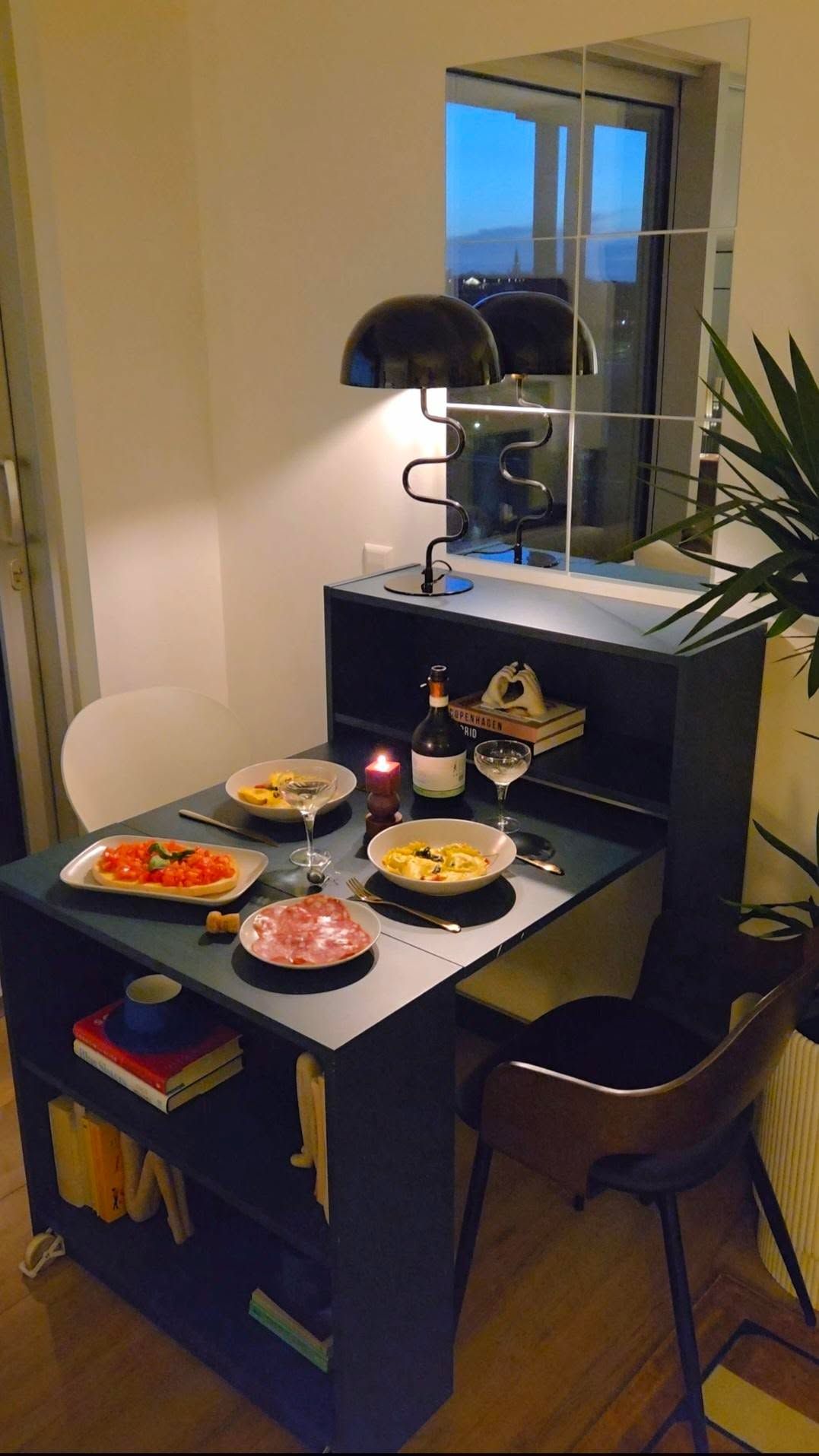 A blue-gray fold-out table with a dinner spread on top.