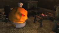 A muffin in a chef's outfit at work in a kitchen.