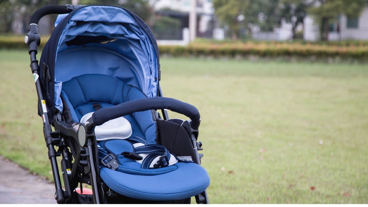 Empty blue stroller in a park