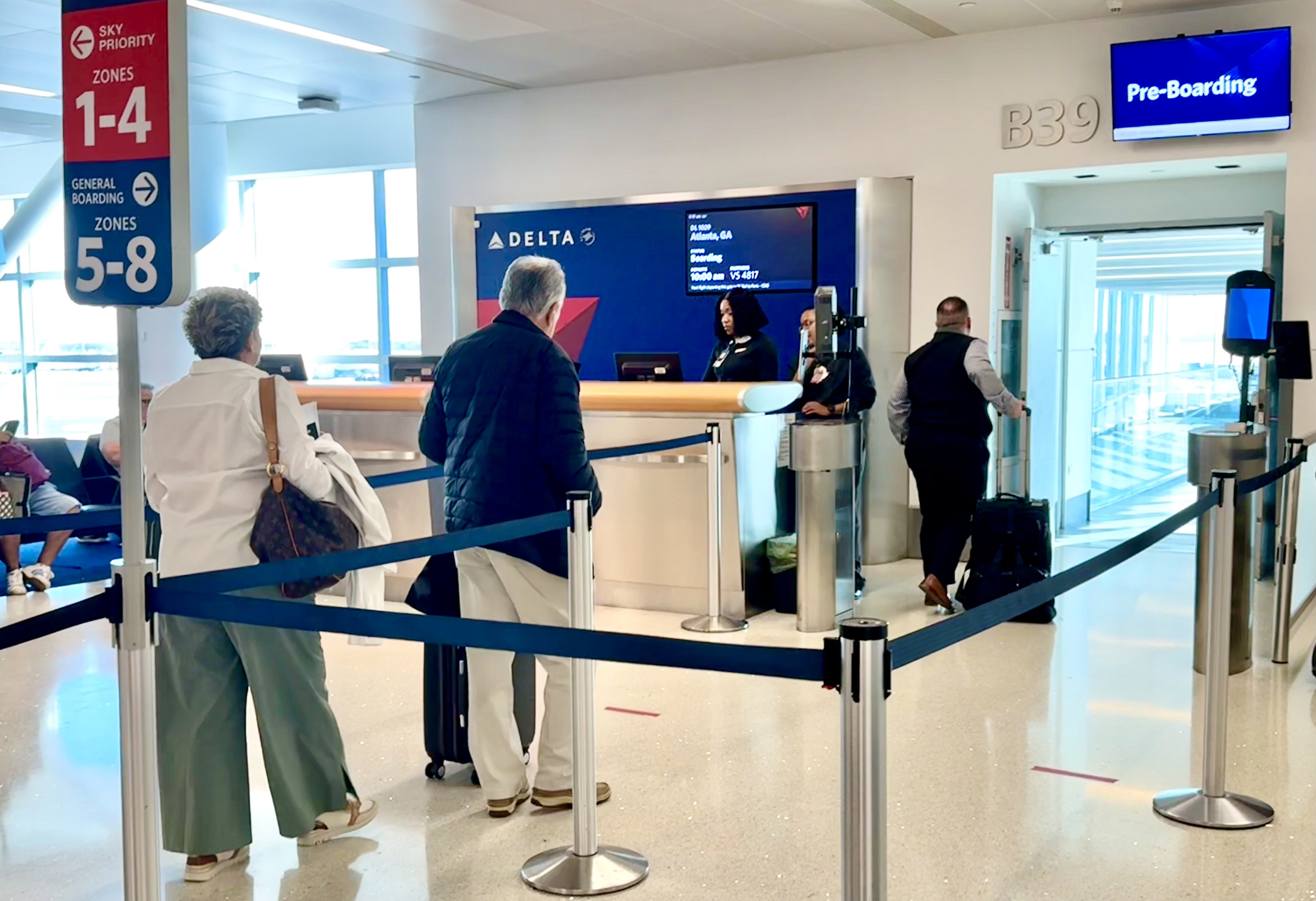 Passengers boarding a Delta flight at the gate.