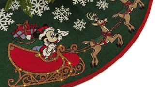 A green and red Mickey tree skirt