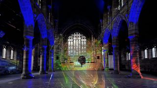 Christie projectors illuminate a 19th-century church in bright images and colors in an immersive storytelling experience. 