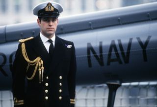 a close up of Prince Andrew posing next to Hms Brazen , A Royal Navy Destroyer in 1986.