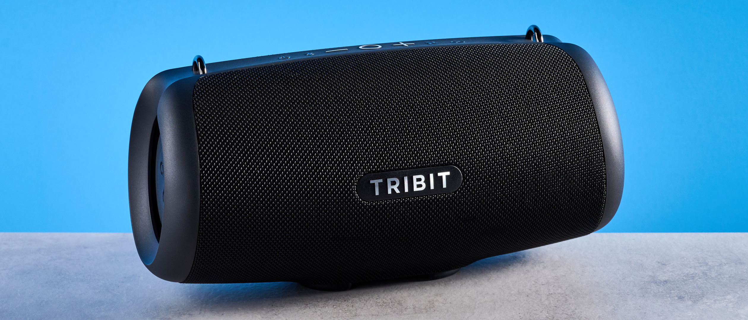 Tribit StormBox Lava Bluetooth Speaker photographed in front of a blue background.