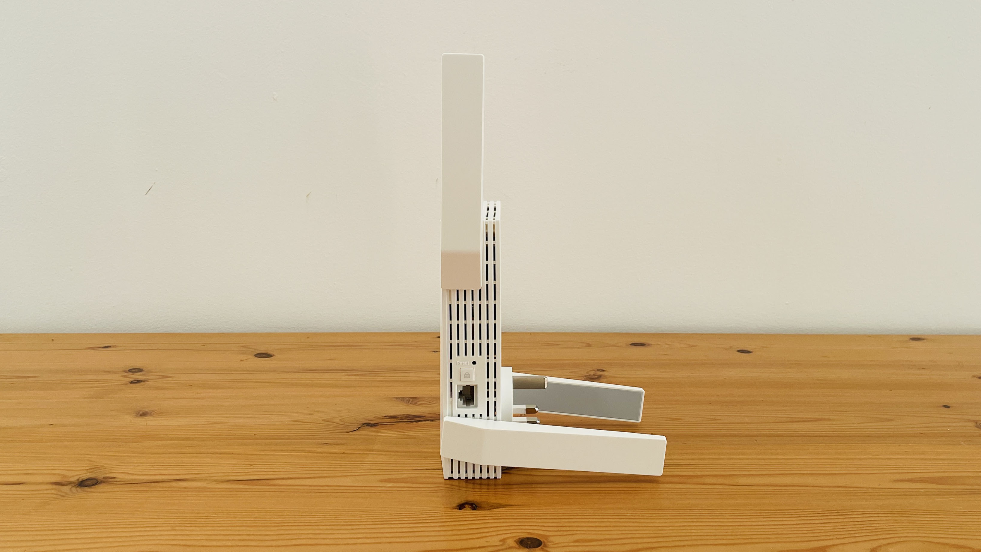 TP-Link AXE5400 range extender on wooden table