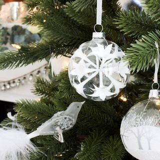 white christmas baubles on christmas tree