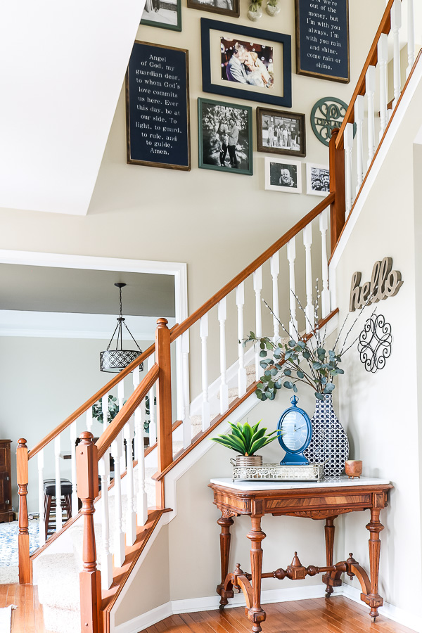 Entryway with gallery wall up the stairs