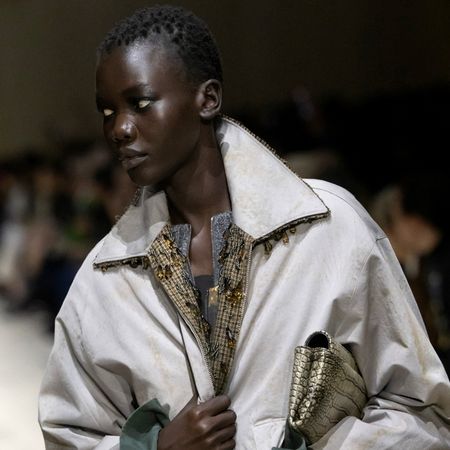 a model on the Prada fall 2026 fashion show runway wearing a beaded barn jacket 