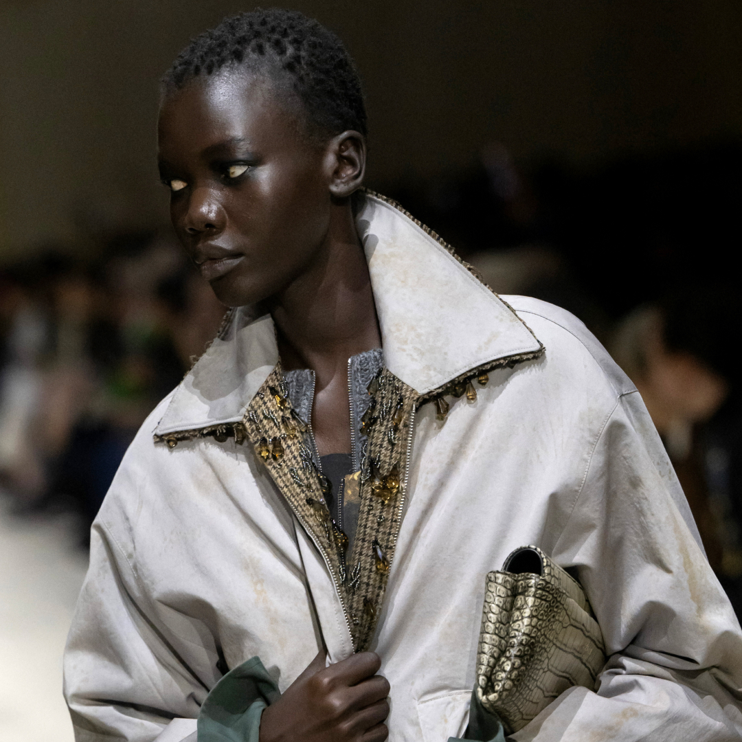 a model on the Prada fall 2026 fashion show runway wearing a beaded barn jacket 