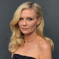 Kirsten Dunst with a curly, side-swept hairstyle