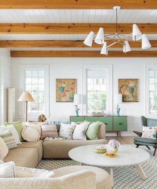 neutral living room with green sideboard and beamed ceiling