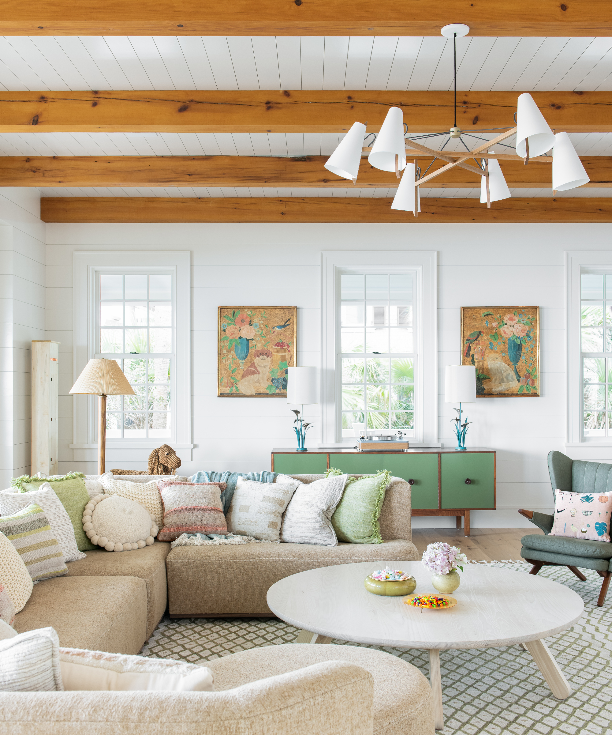 neutral living room with green sideboard and beamed ceiling