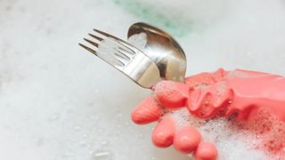 Washing cutlery in soapy water