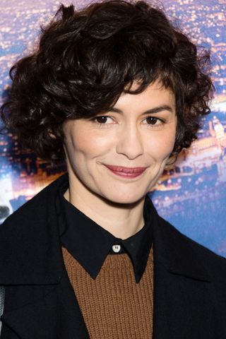 Audrey Tautou is pictured with short curly hair at the "Santa & Cie" Paris Premiere at Cinema Pathe Beaugrenelle on December 3, 2017 in Paris, France.