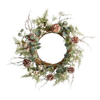 A leafy Christmas wreath decorated with pinecones and twigs