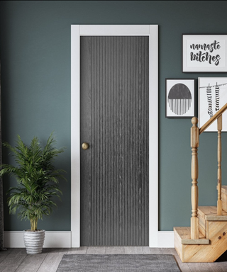 Picture of a modern grey door in a hallway with a grooved pattern on it