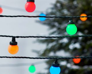 colorful outdoor lights in red, green, blue and orange on a black string