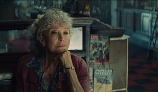 Rita Moreno sits at her counter in West Side Story.