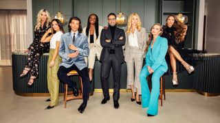 Lauren, Olivia, Oli, Reme, Daniel, Rosi, Rasa, and Julianna pose in a kitchen.