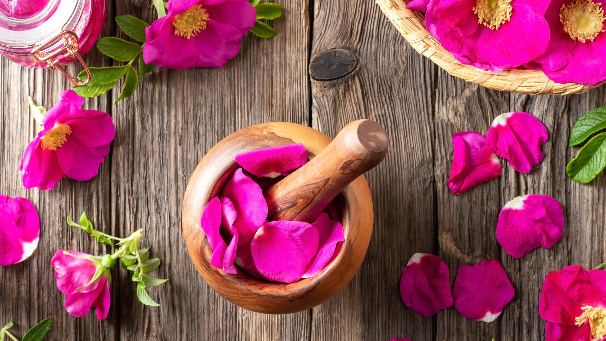pink rose petals and pestle and mortar on table